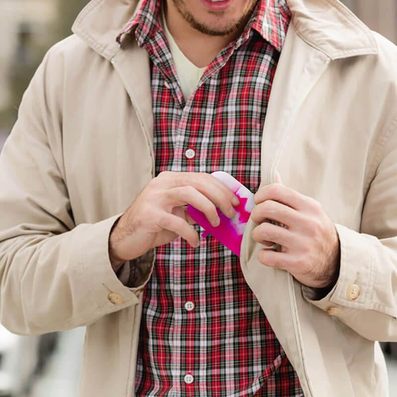 Man holding PILOT DIARY Silicone Dugout One Hitter Set in Pink, compact for easy travel