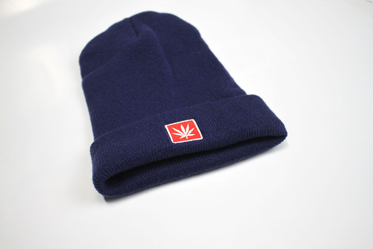 StonerDays Navy Blue Acrylic Beanie with Red Leaf Emblem, Angled View on White