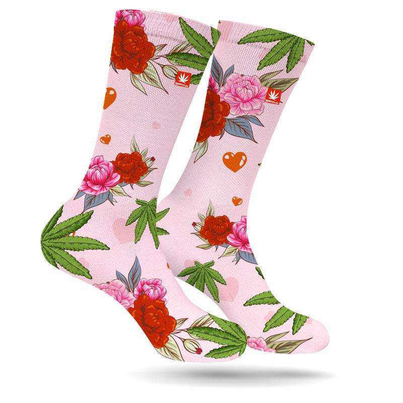 StonerDays pink cannabis socks with floral design and hearts, front view on white background