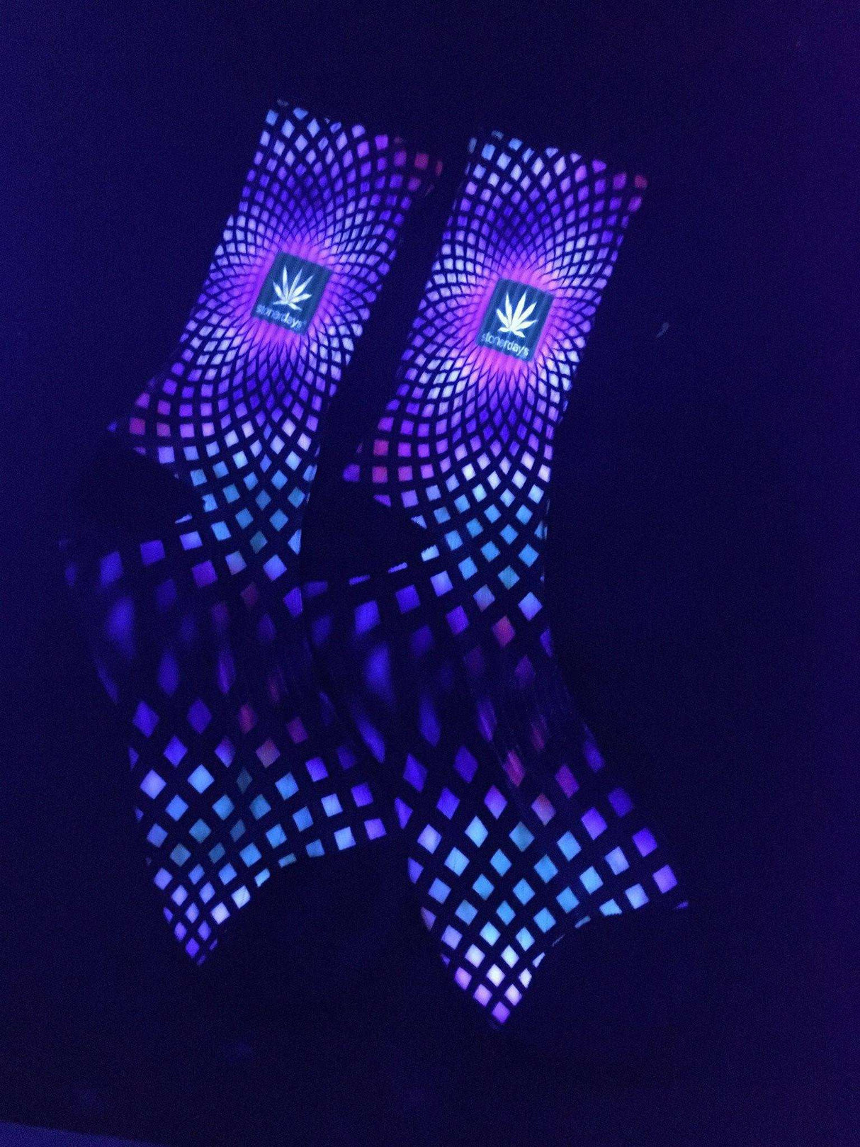 StonerDays black socks with UV reactive full spectrum weed design, glowing under blacklight