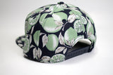 StonerDays Lime Trees Snapback in black with green leaf print, side view on white background