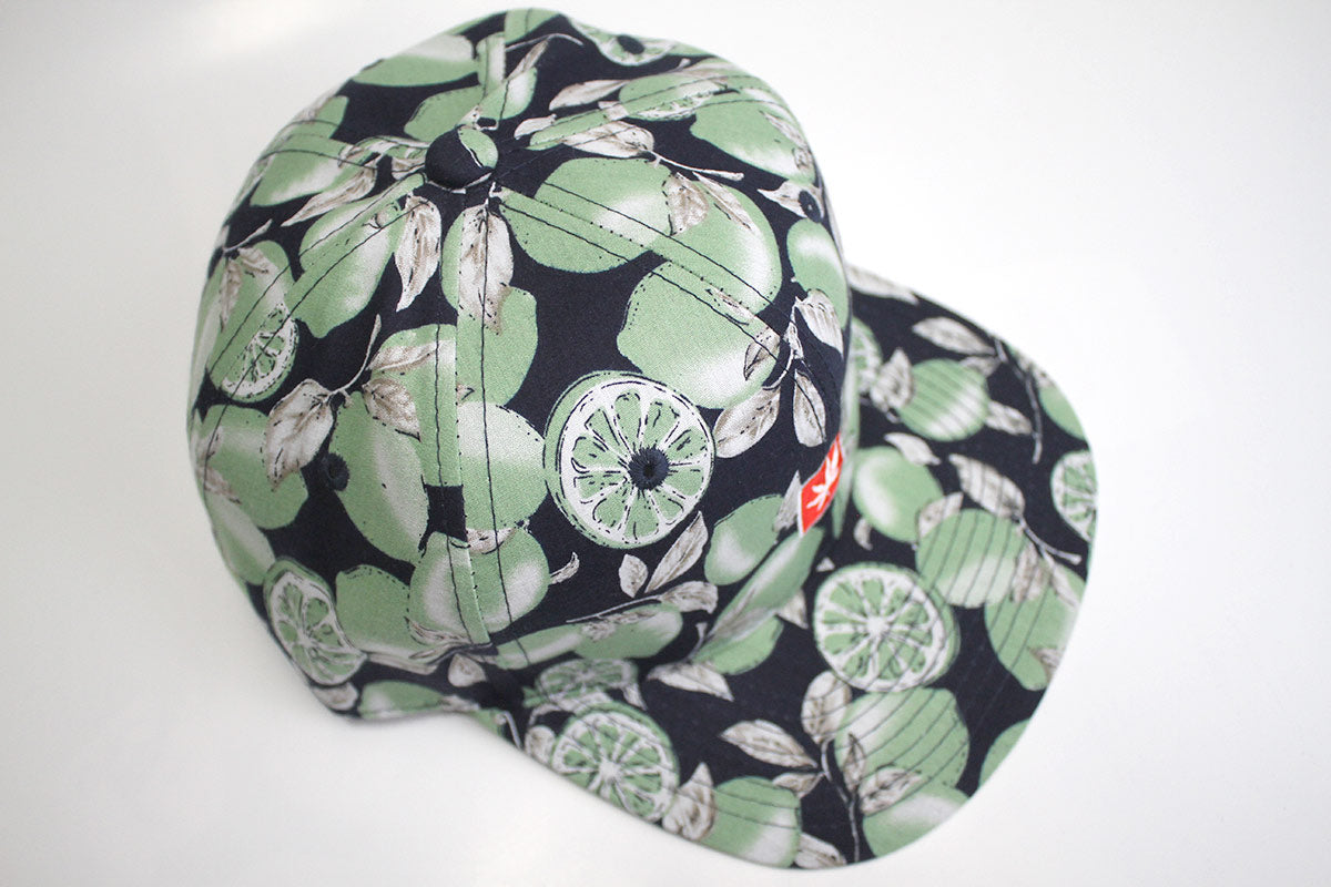 StonerDays Lime Trees Snapback in black with green leaf print, side view on white background