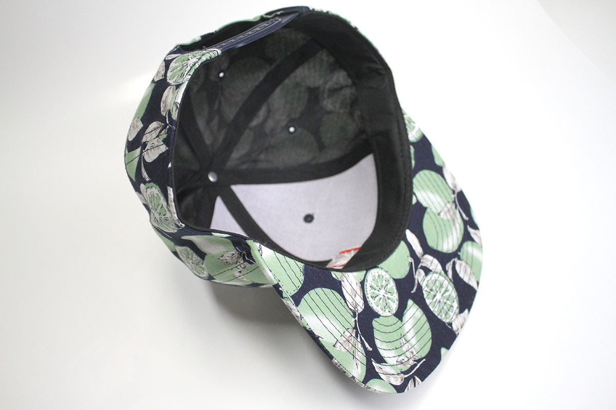 StonerDays Lime Trees Snapback with black brim and green leaf print, top view on white background