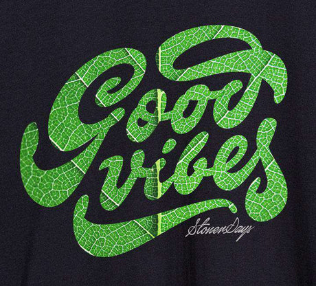 Close-up of StonerDays Men's Groovy Vibes Tank Top in black with green print