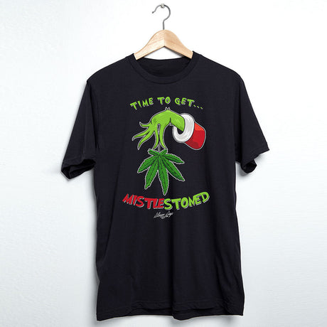 StonerDays Mistlestoned men's black t-shirt with green cannabis leaf graphic, front view on hanger