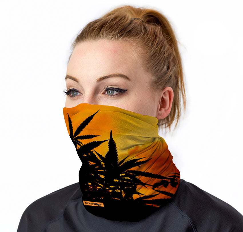 StonerDays Neck Gaiter featuring a cannabis silhouette against a sunset, front view on a model