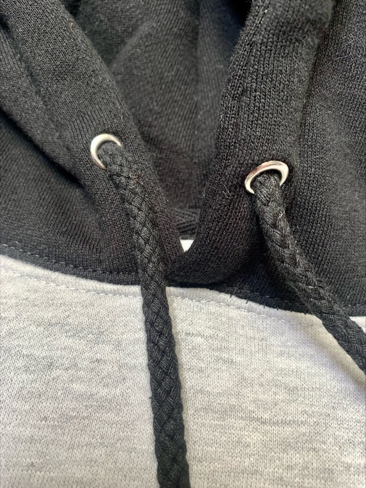 Close-up of StonerDays Two Tone Hoodie in black and grey, showcasing drawstring detail.