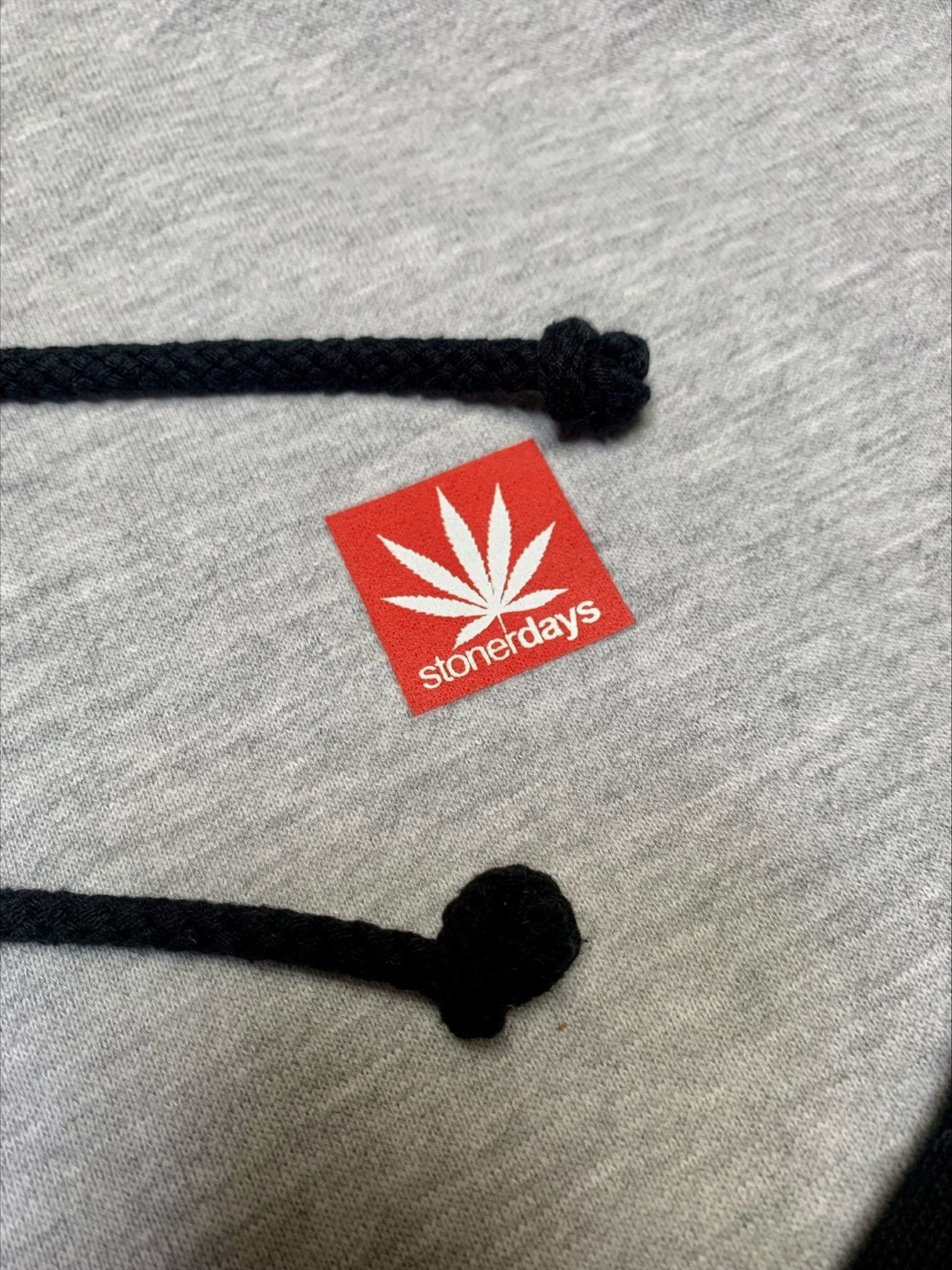 Close-up of StonerDays Two Tone Hoodie with logo, showcasing drawstrings and quality fabric