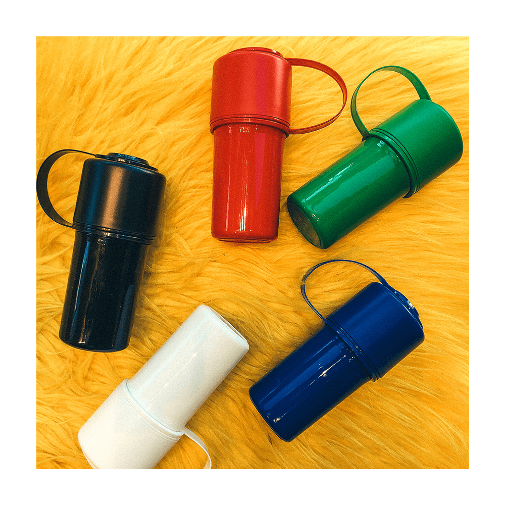 Hemper The Keeper grinders in black, red, green, white, and blue on a fuzzy yellow background