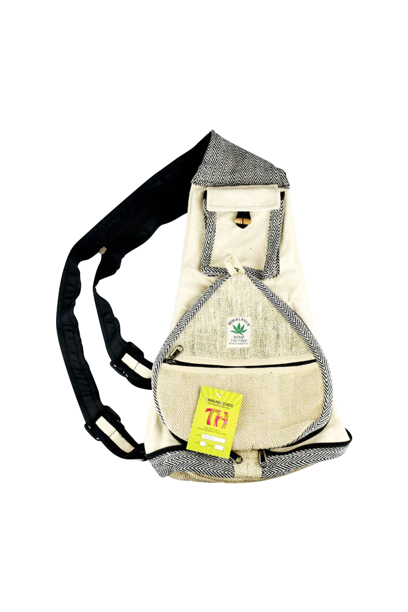 ThreadHeads Himalayan Hemp Convertible Sling Pack in tan with black accents, front view on white background.