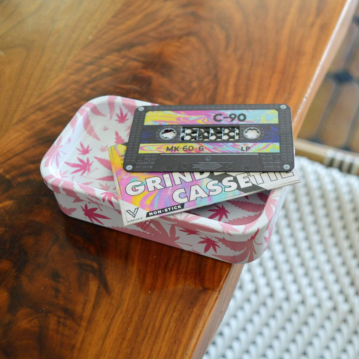 V Syndicate Cassette Nonstick Grinder Card on wooden surface, compact and portable design