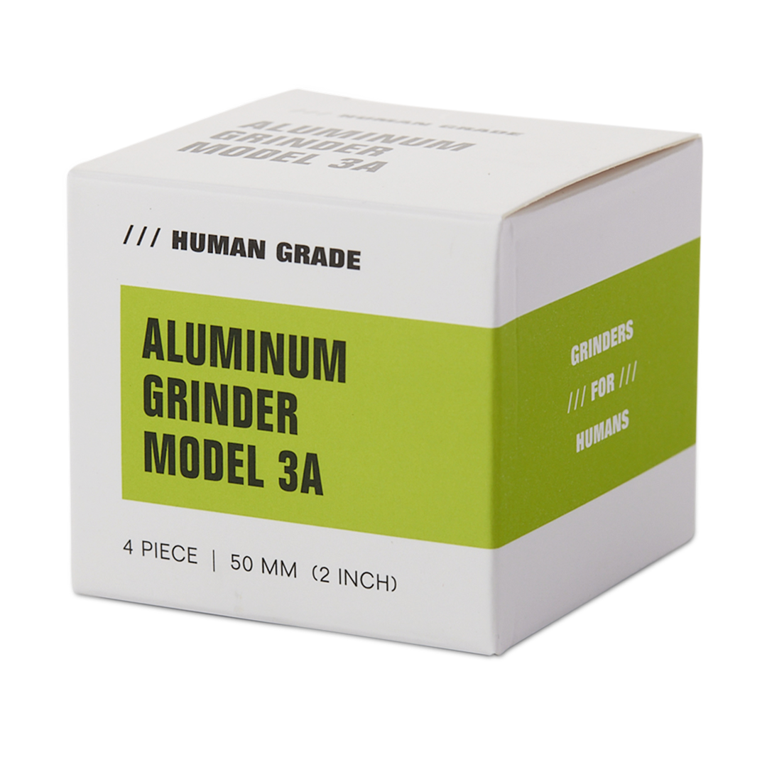 Human Grade 3A Aluminum Grinder in packaging, 2" 4-Piece, front view on white background