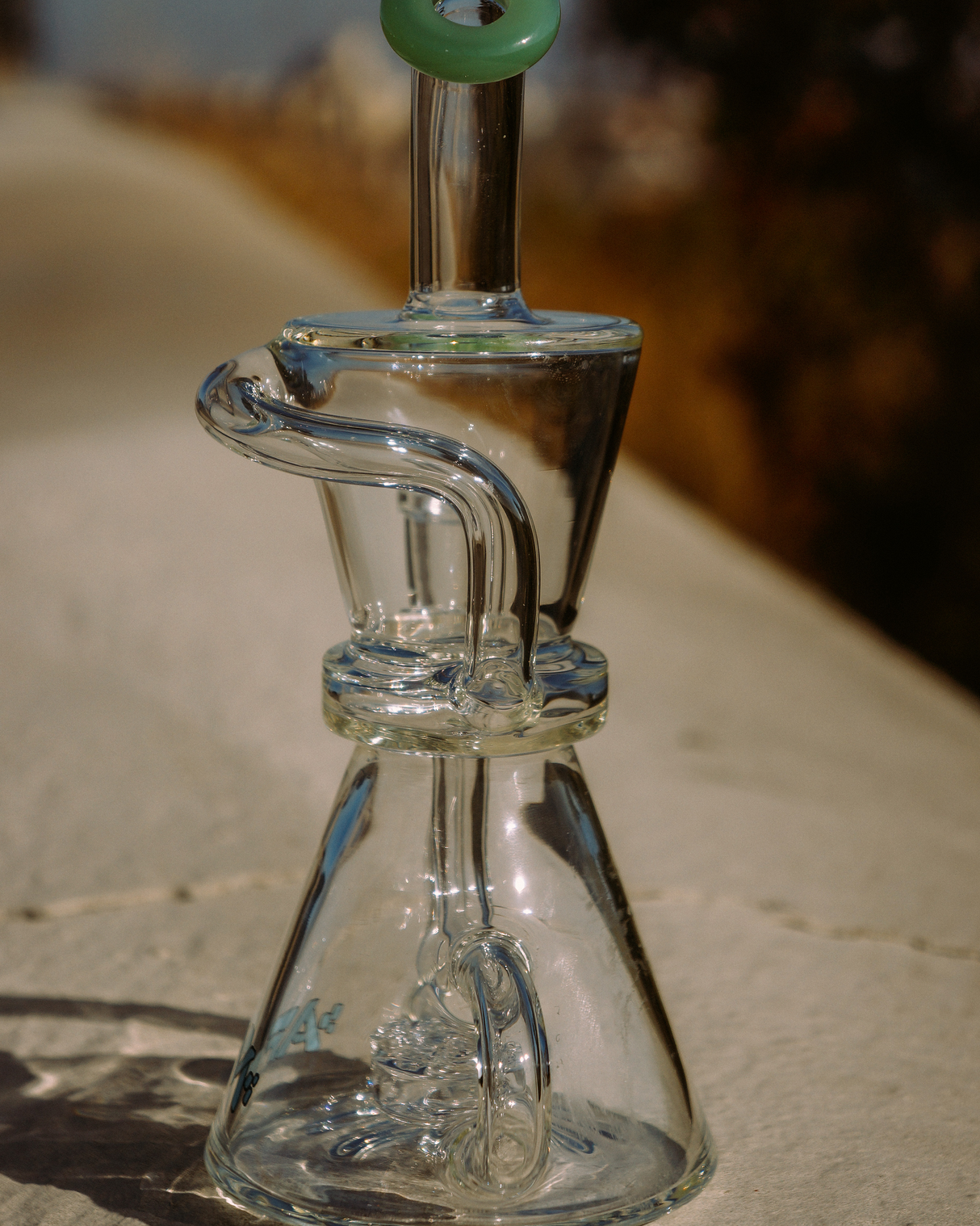 AFM 8.5" Hour Glass Clear Recycler Dab Rig with Showerhead Perc, Side View on Natural Backdrop