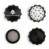 Kozo 2 inch four-piece aluminum grinder in black, four pieces laid flat showing lid, teeth, screen and base