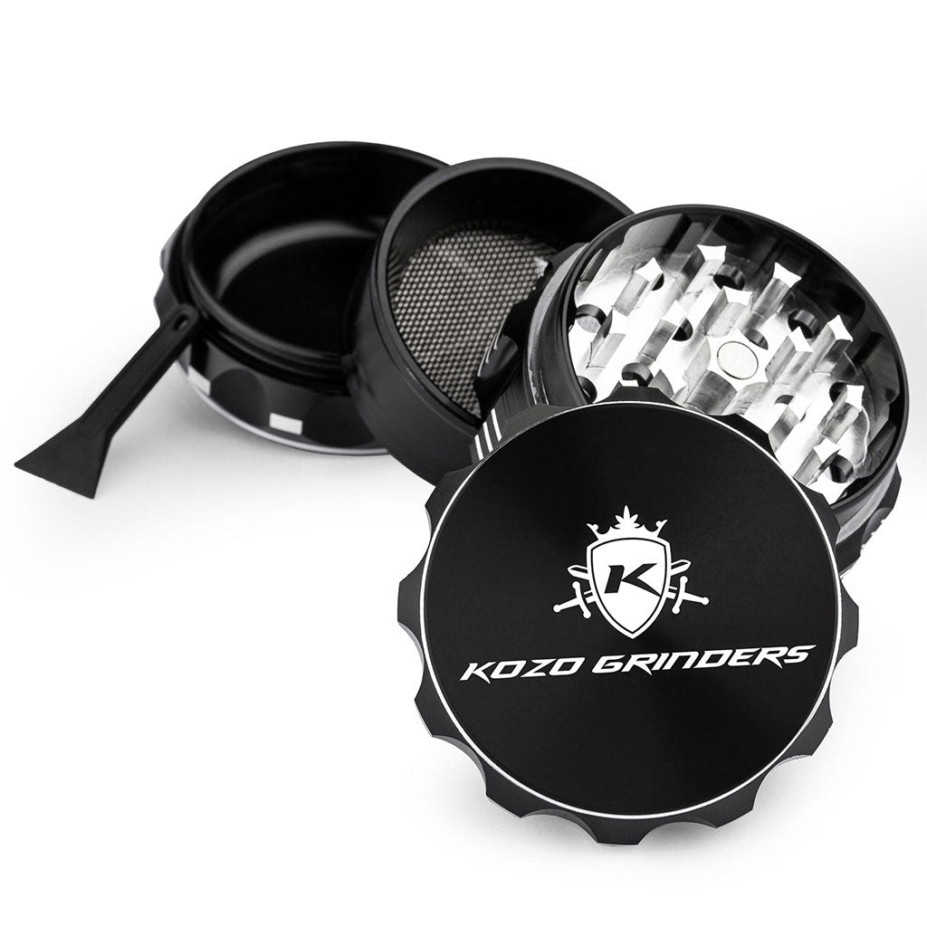 Kozo 2 inch four-piece aluminum grinder in black, split into four pieces with the pollen scraper