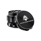 Kozo 2 inch four-piece aluminum grinder in black, lid tilted open beside the toothed grinding chamber