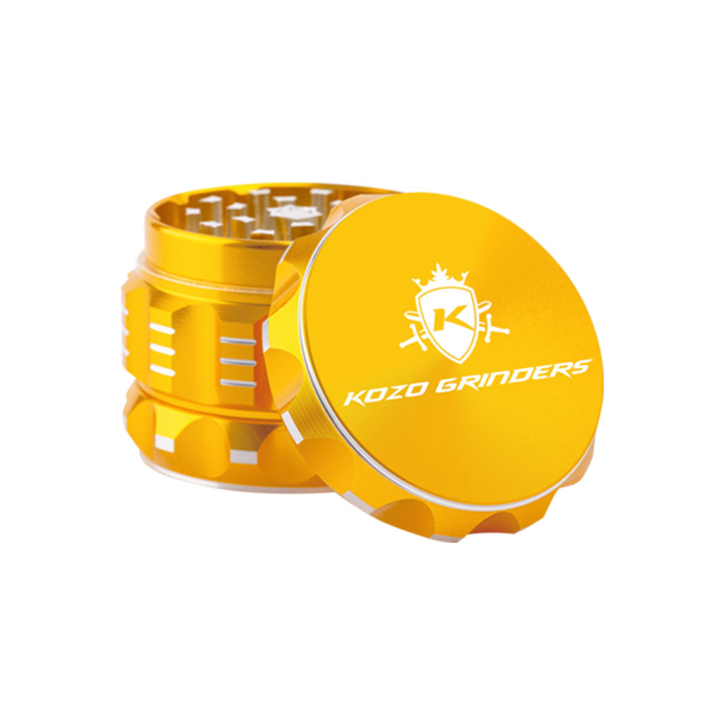 Kozo 2 inch four-piece aluminum grinder in gold, lid tilted open beside the toothed grinding chamber
