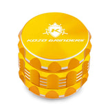 Kozo 2 inch four-piece aluminum grinder in gold, closed front view of the body with the Kozo logo lid
