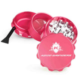 Kozo 2 inch four-piece aluminum grinder in pink, split into four pieces with the pollen scraper