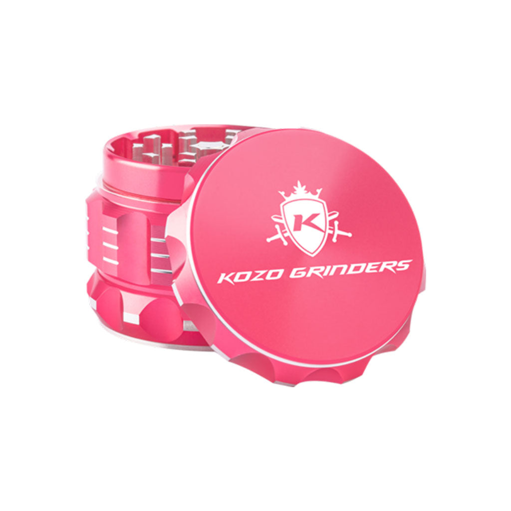 Kozo 2 inch four-piece aluminum grinder in pink, lid tilted open beside the toothed grinding chamber