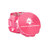 Kozo 2 inch four-piece aluminum grinder in pink, lid tilted open beside the toothed grinding chamber
