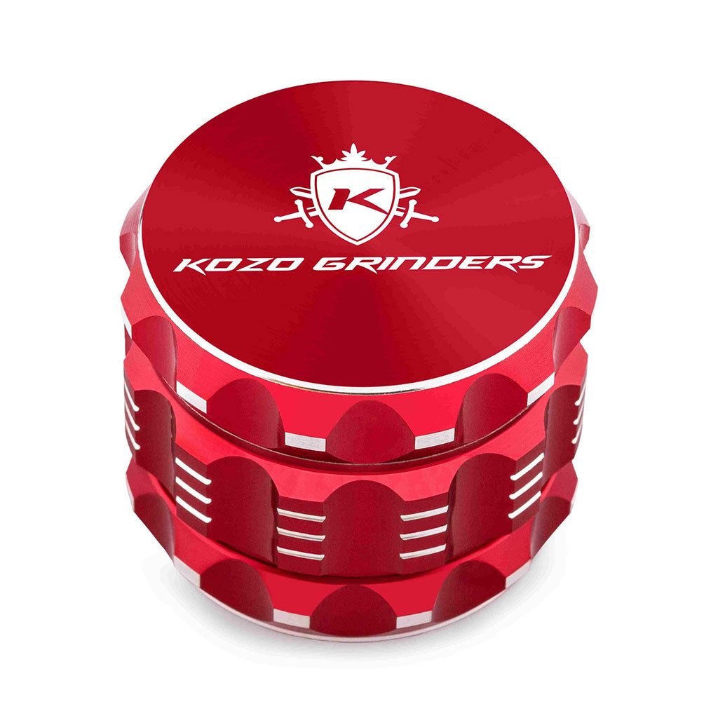 Kozo 2 inch four-piece aluminum grinder in red, closed front view of the body with the Kozo logo lid
