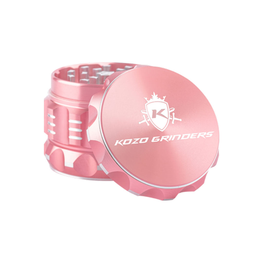 Kozo 2 inch four-piece aluminum grinder in rose gold, lid tilted open beside the toothed grinding chamber
