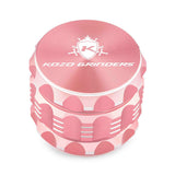 Kozo 2 inch four-piece aluminum grinder in rose gold, closed front view of the body with the Kozo logo lid