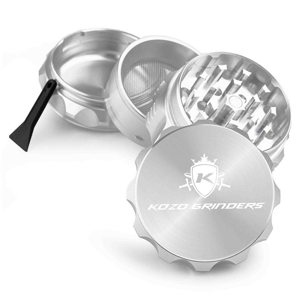 Kozo 2 inch four-piece aluminum grinder in silver, split into four pieces with the pollen scraper