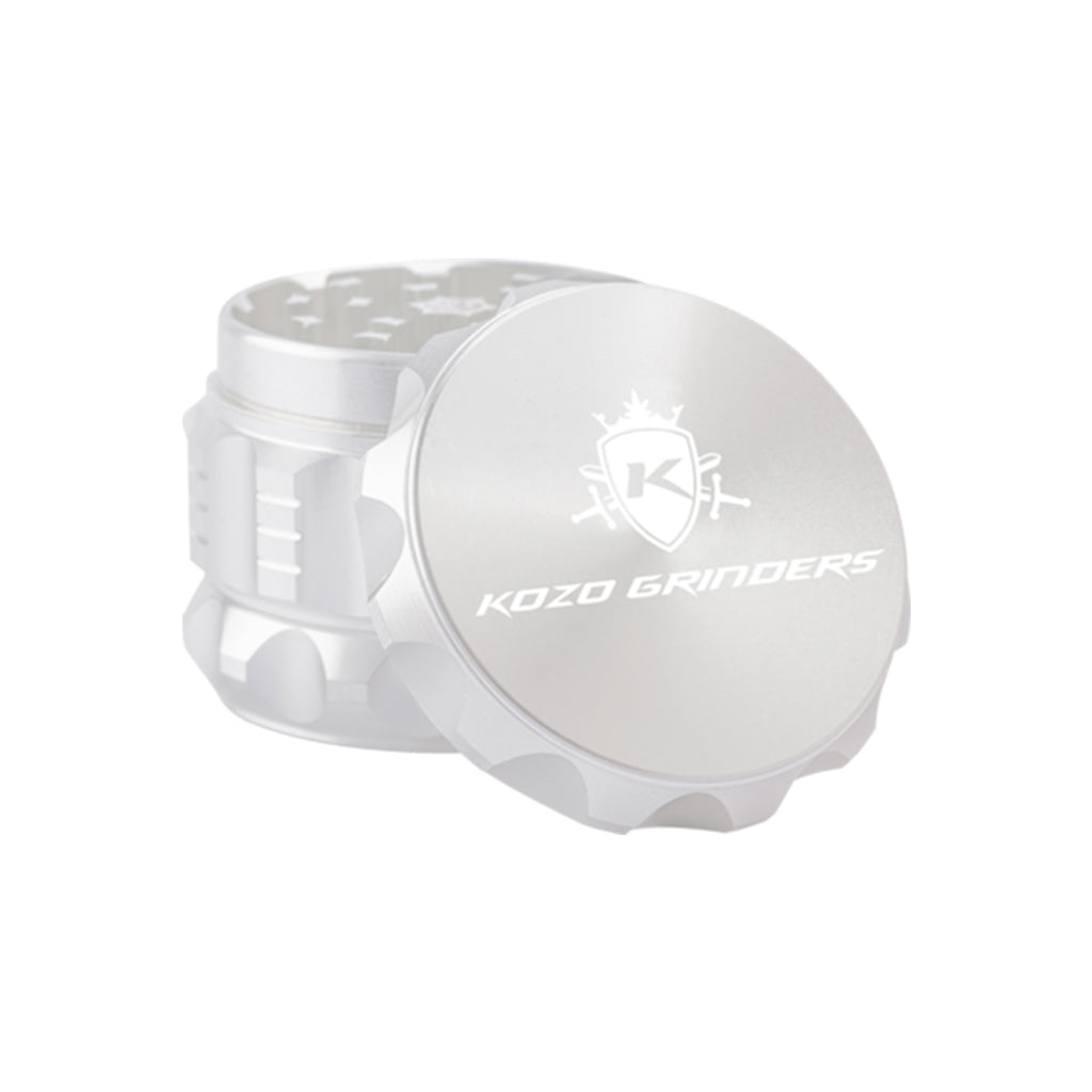 Kozo 2 inch four-piece aluminum grinder in silver, lid tilted open beside the toothed grinding chamber