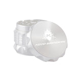 Kozo 2 inch four-piece aluminum grinder in silver, lid tilted open beside the toothed grinding chamber