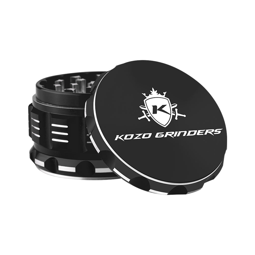 Kozo 3 inch four-piece anodized aluminum grinder in black, lid tilted open beside the toothed grinding chamber