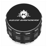 Kozo 3 inch four-piece anodized aluminum grinder in black, closed front view of the body with the Kozo logo lid