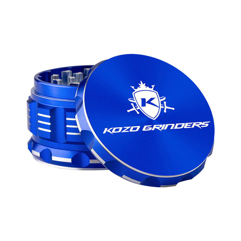 Kozo 3 inch four-piece anodized aluminum grinder in blue, lid tilted open beside the toothed grinding chamber