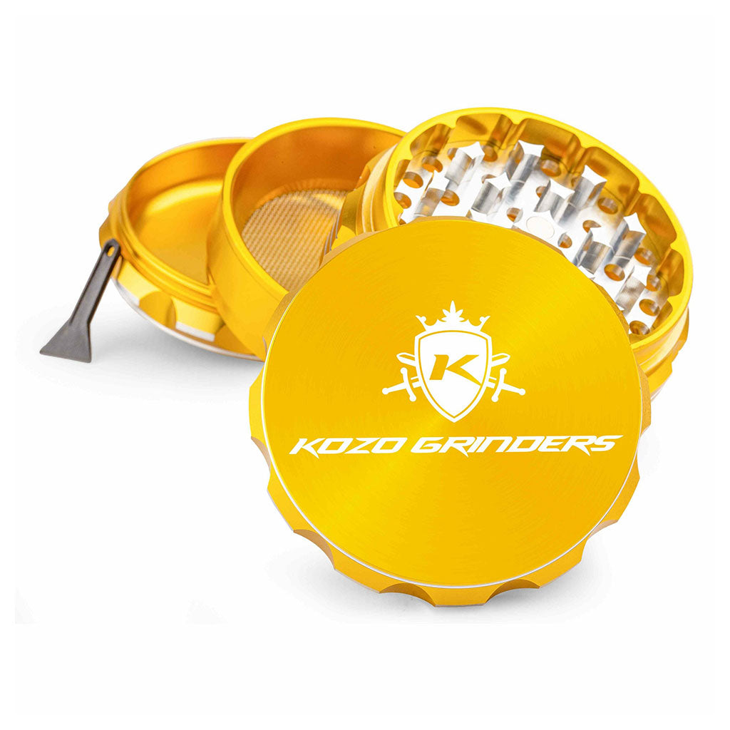 Kozo 3 inch four-piece anodized aluminum grinder in gold, split into four pieces with the pollen scraper