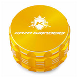 Kozo 3 inch four-piece anodized aluminum grinder in gold, closed front view of the body with the Kozo logo lid