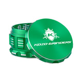 Kozo 3 inch four-piece anodized aluminum grinder in green, lid tilted open beside the toothed grinding chamber