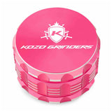 Kozo 3 inch four-piece anodized aluminum grinder in pink, closed front view of the body with the Kozo logo lid