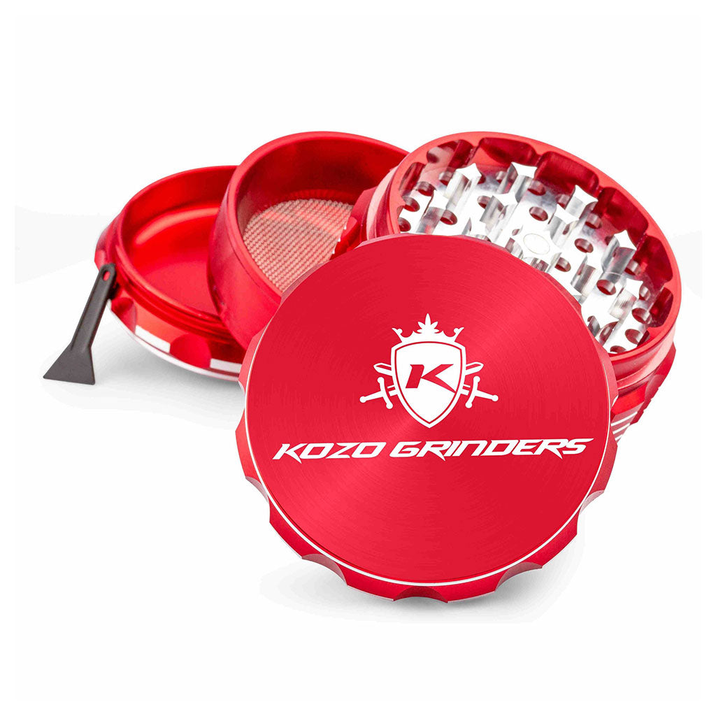 Kozo 3 inch four-piece anodized aluminum grinder in red, split into four pieces with the pollen scraper