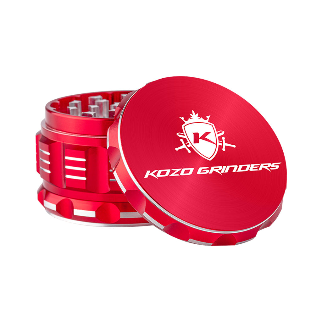 Kozo 3 inch four-piece anodized aluminum grinder in red, lid tilted open beside the toothed grinding chamber