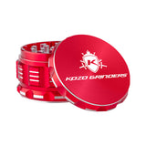 Kozo 3 inch four-piece anodized aluminum grinder in red, lid tilted open beside the toothed grinding chamber