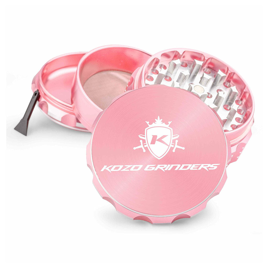 Kozo 3 inch four-piece anodized aluminum grinder in rose gold, split into four pieces with the pollen scraper