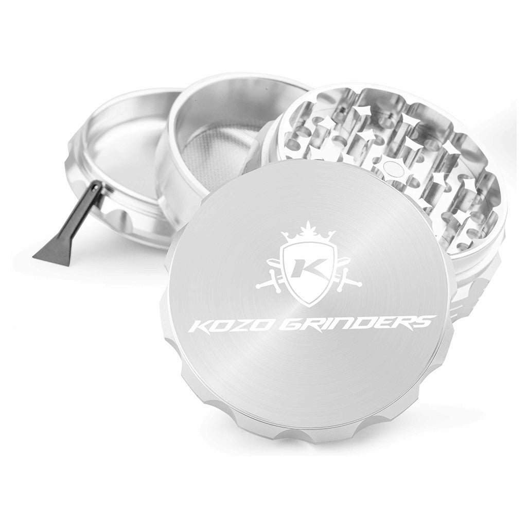 Kozo 3 inch four-piece anodized aluminum grinder in silver, split into four pieces with the pollen scraper
