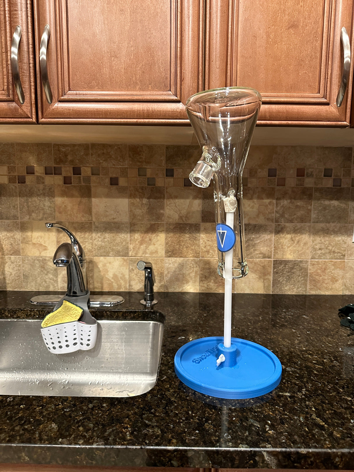 Snowtree Glass Drying Rack in kitchen, clear bong on blue stand with secure hold