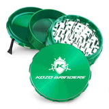Kozo 4 inch four-piece anodized aluminum grinder in green, split into four pieces with the pollen scraper