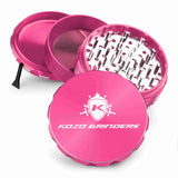 Kozo 4 inch four-piece anodized aluminum grinder in pink, split into four pieces with the pollen scraper