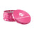 Kozo 4 inch four-piece anodized aluminum grinder in pink, lid tilted open beside the toothed grinding chamber