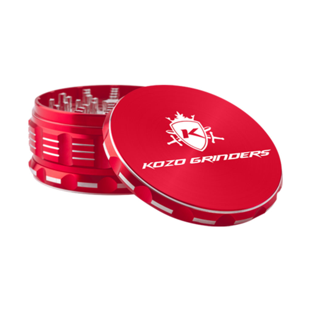 Kozo 4 inch four-piece anodized aluminum grinder in red, lid tilted open beside the toothed grinding chamber