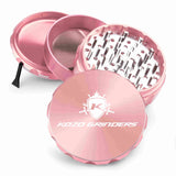 Kozo 4 inch four-piece anodized aluminum grinder in rose gold, split into four pieces with the pollen scraper