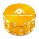 Kozo 4 inch four-piece anodized aluminum grinder in gold, closed front view of the body with the Kozo logo lid